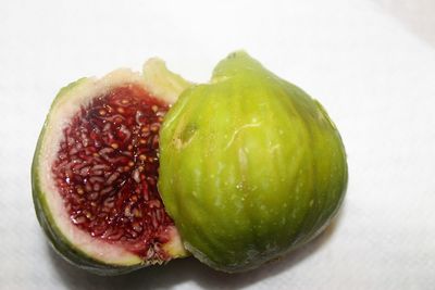 Close-up of fruits on table against white background