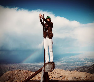 Man standing at observation point against sky