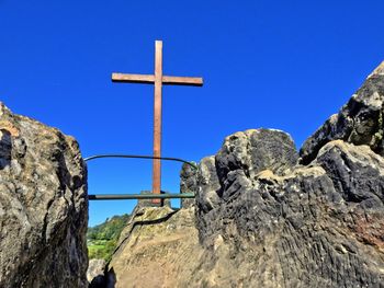 Low angle view of mountain against blue sky