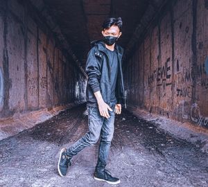 Full length of man standing against wall