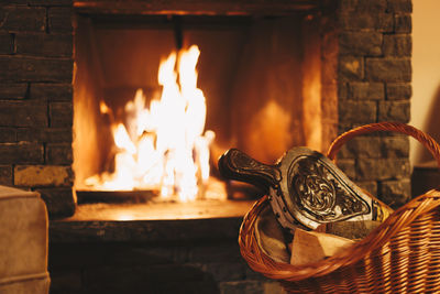 Burning fireplace with wooden logs and fire blower