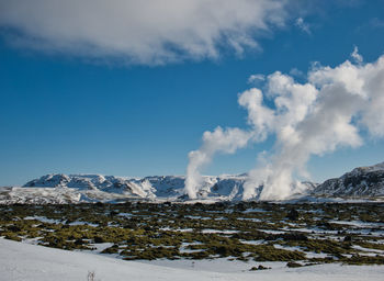 Scenic view of snowcapped mountains against sky