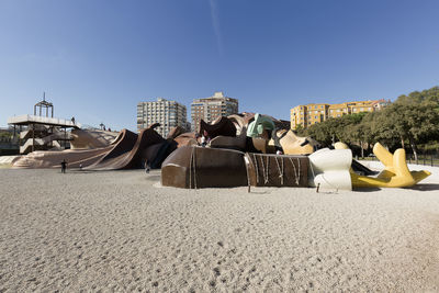 Panoramic view of beach against clear blue sky