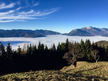 Scenic view of lake and mountains against blue sky