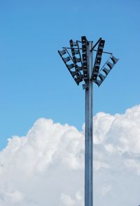 Low angle view of speakers against blue sky