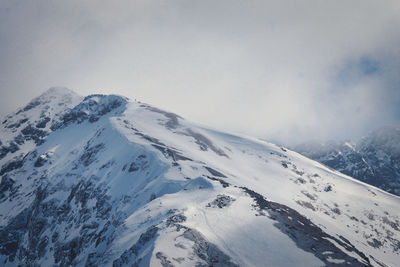Scenic view of snow covered mountains against sky