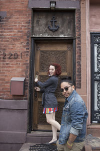 Young couple on a doorstep.