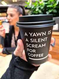 Woman holding coffee cup