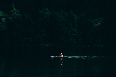 Rear view of man swimming in lake