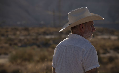Side view of young woman looking away outdoors