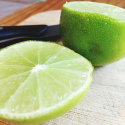 Close-up of green lemon on table