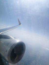 Close-up of airplane wing against sky