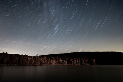 Scenic view of lake against sky at night