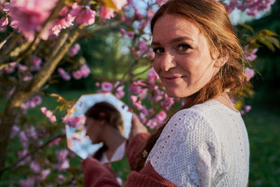 Portrait of smiling woman against plants