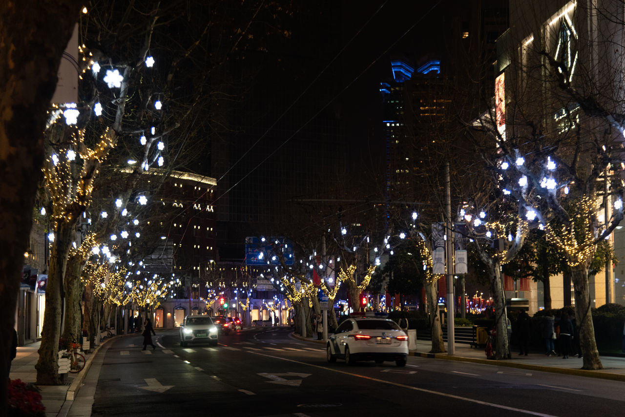 PANORAMIC VIEW OF ILLUMINATED CITY STREET