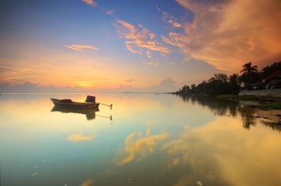 Scenic view of lake against sky during sunset