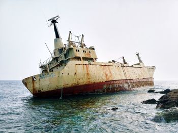 Traditional ship on sea against clear sky