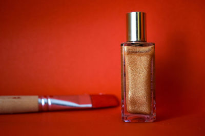 Close-up of metallic object on table against red background