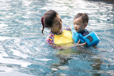 Children playing in swimming pool