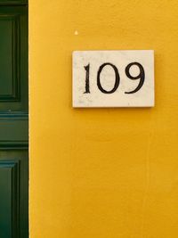 Close-up of yellow information sign