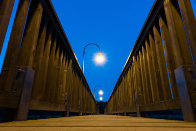 Low angle view of illuminated street light against clear sky