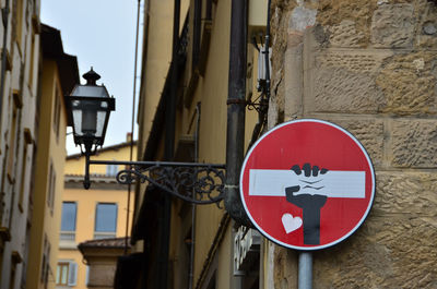 Low angle view of road sign on building