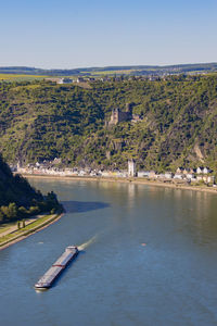 Scenic view of river by trees against sky