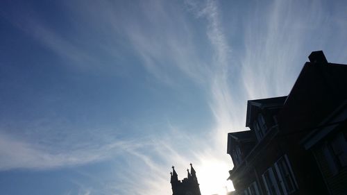 Low angle view of silhouette buildings against sky