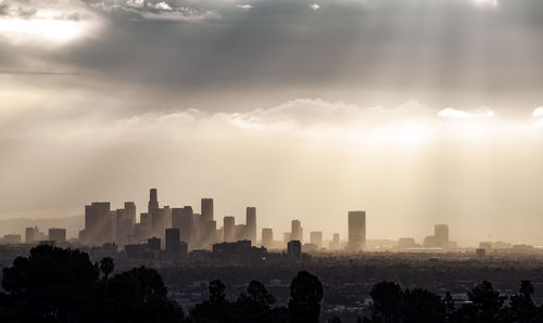 Cityscape against sky during sunset