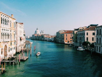 View of boats in canal in city