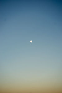 Low angle view of moon against clear sky at night