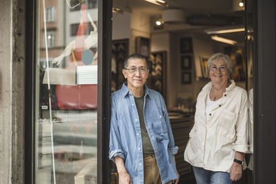 Portrait of male and female coworkers at shop