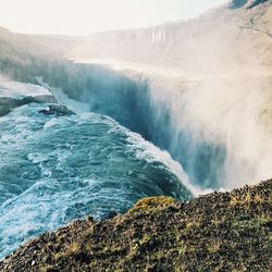 Scenic view of waterfall against sky