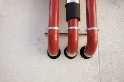 Close up of red pipes on wall