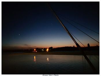 Scenic view of lake against sky at night