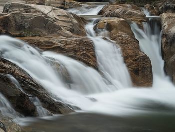 View of waterfall along rocks
