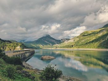 Scenic view of lake and mountains against sky