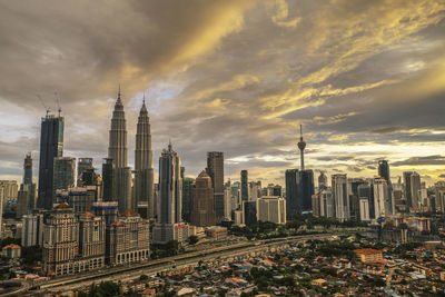 View of cityscape against cloudy sky