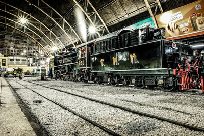 Train at railroad station platform at night