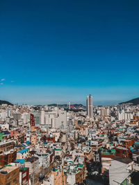 High angle view of buildings against blue sky