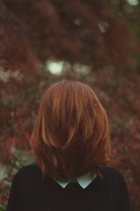 Rear view of woman with autumn leaves