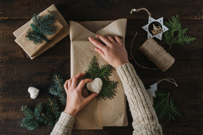 Giving tuesday, give, help, donation, support, volunteer concept with female hands wrapping box 