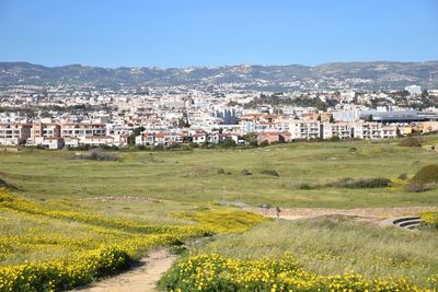 Scenic view of townscape by buildings against clear sky