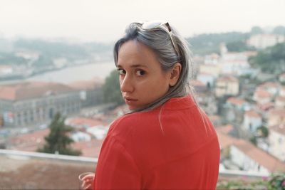 Portrait of woman against cityscape