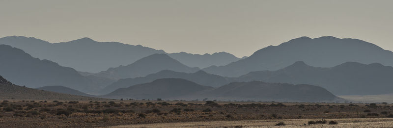 Scenic view of mountains against clear sky during sunset