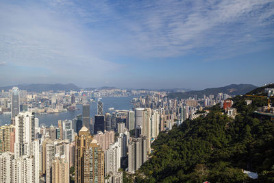 Aerial view of buildings in city against sky