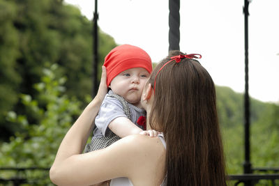 Young woman holding baby boy