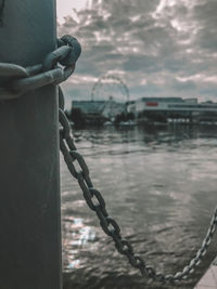 Close-up of chain on metal fence