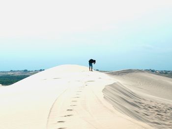 Rear view of man walking on beach