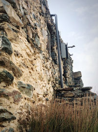 Low angle view of rock formation against sky